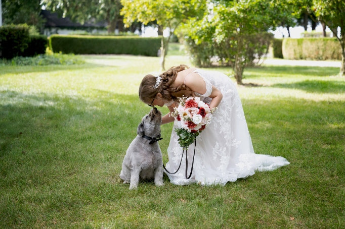 Jorie poses with her dog Cubbie at her wedding. She shares the love and light that Cubbie brings into her life.