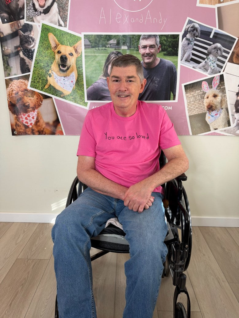 Uncle Andy is in his wheelchair wearing a "You Are So Loved" shirt. He reminds people that they are loved, valued, and wanted. 