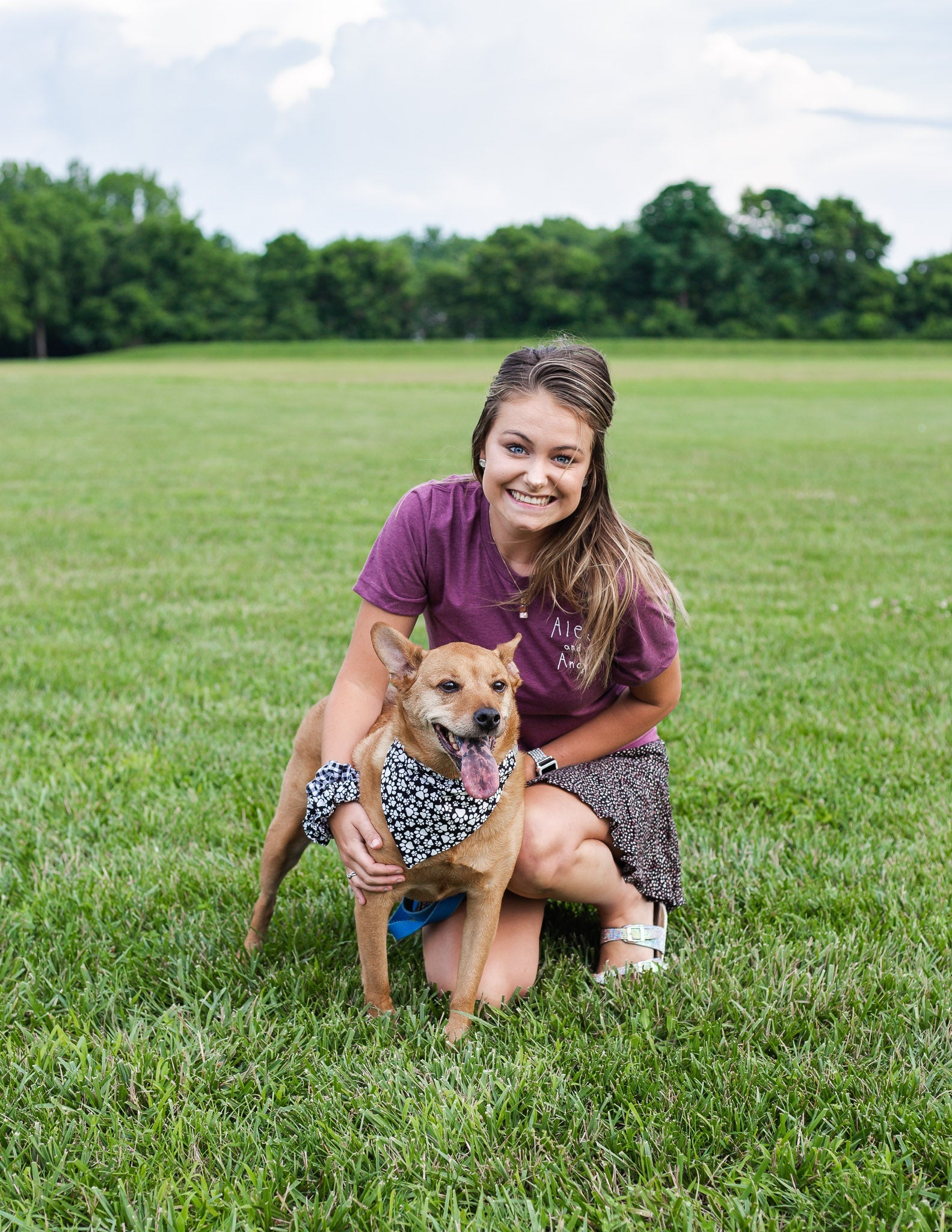 Sophie, a business owner, poses with her dog Alex for a photoshoot. Alex is wearing a reversible pet bandana sold by Alex And Andy.